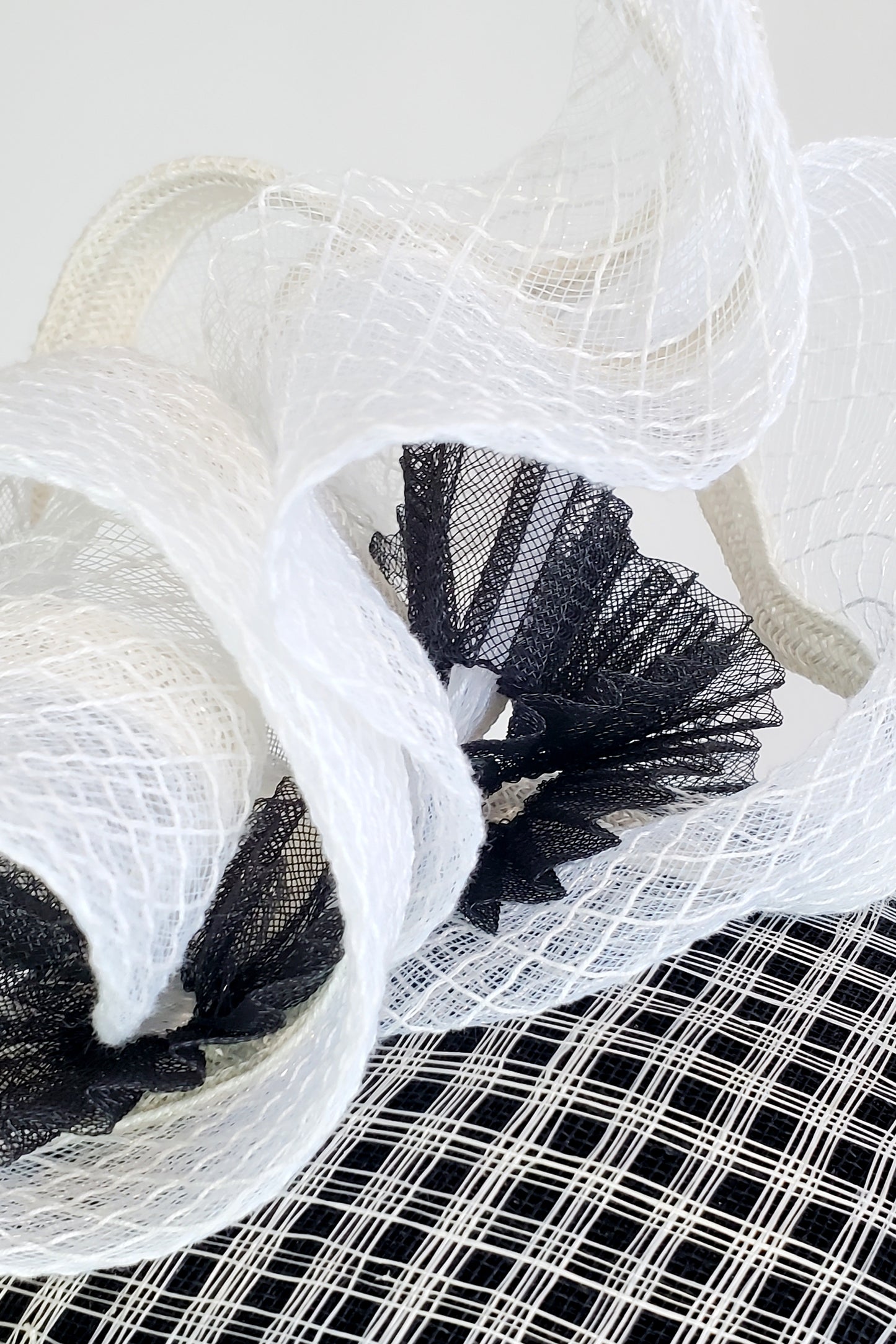White and black fascinator hat. Decoration close-up