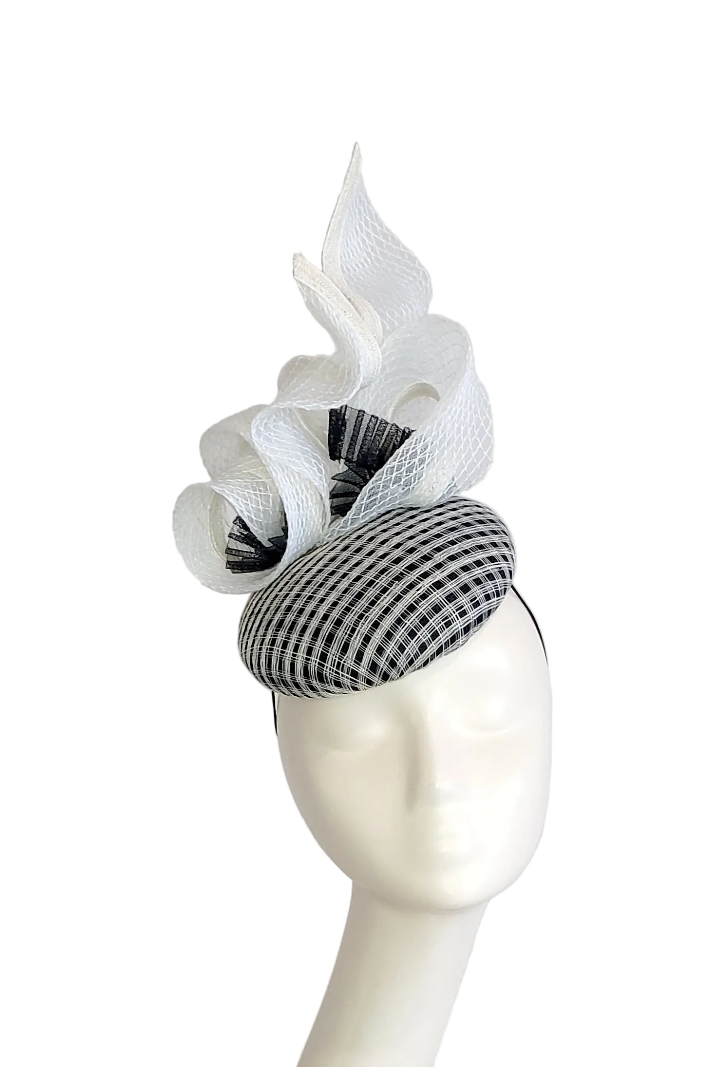 A black and white checkered fascinator hat , displayed on a white mannequin head against a white background.