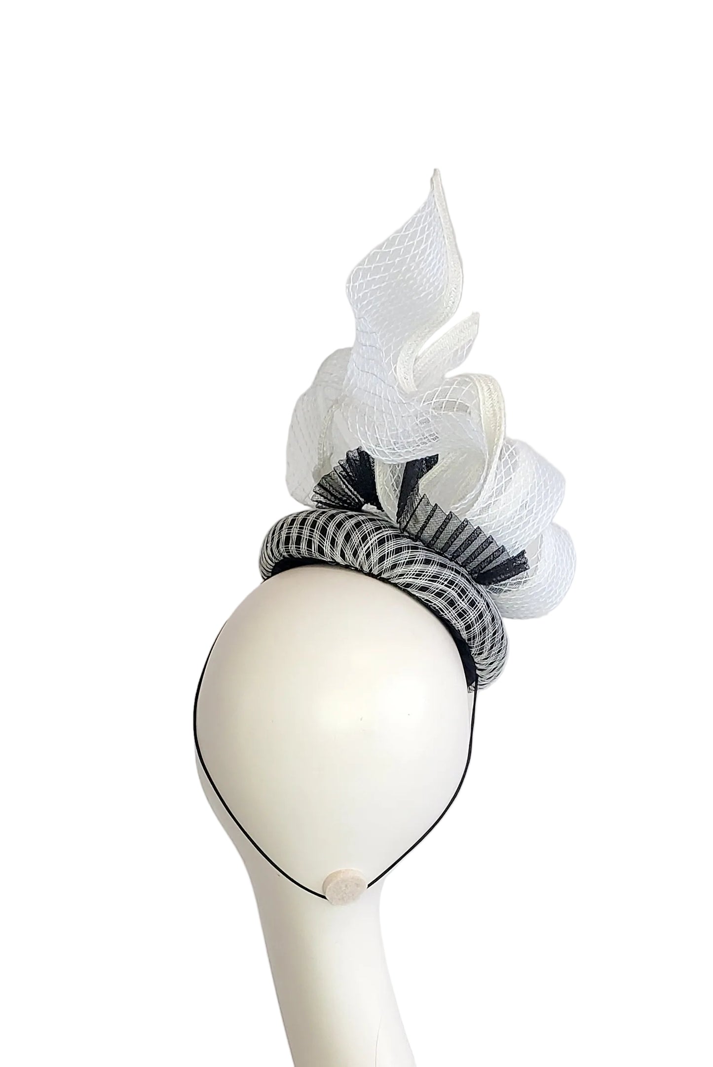 A black and white fascinator headpiece s, displayed on a white mannequin head against a white background.