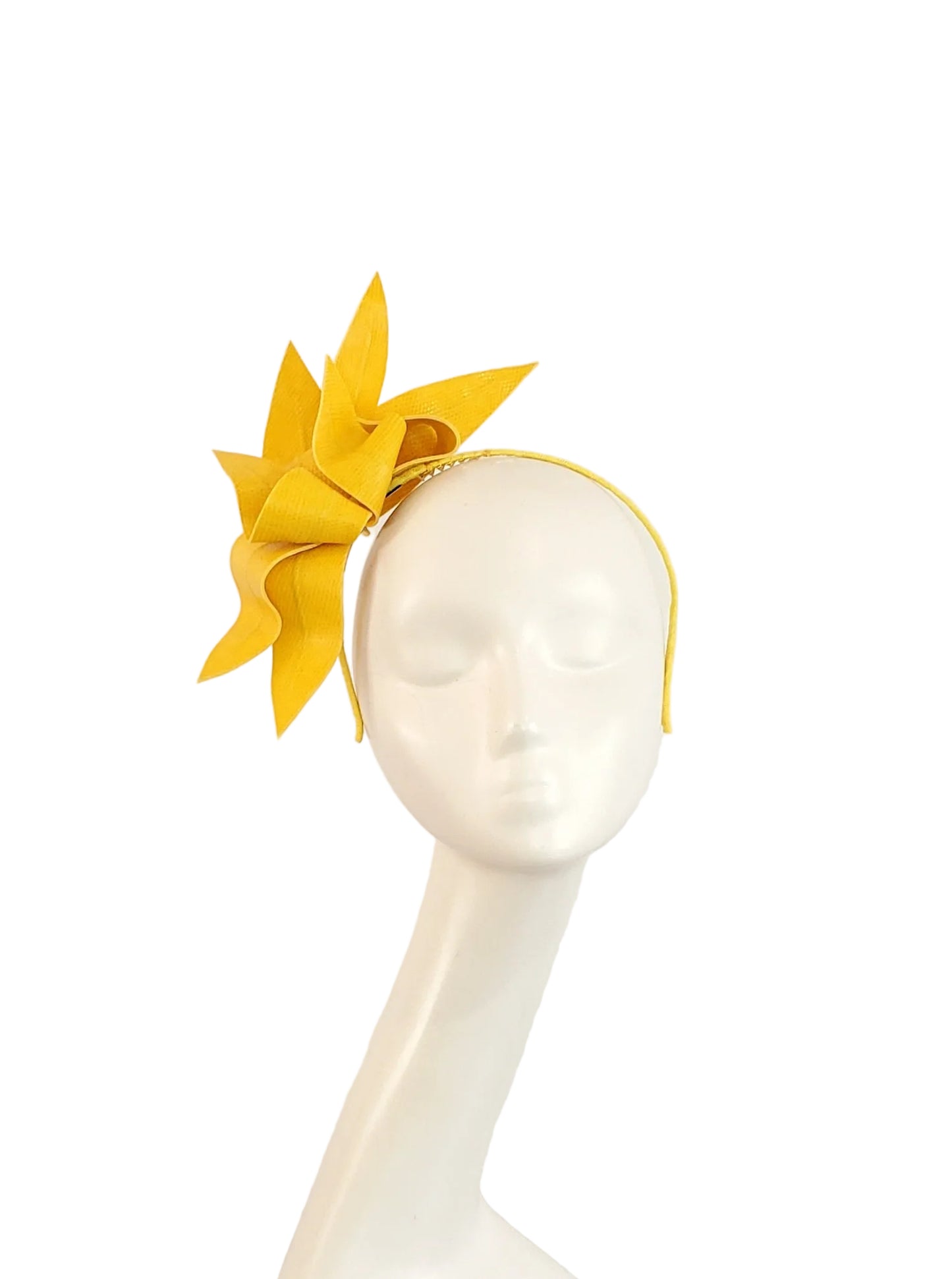 A bright yellow fascinator headpiece with a thin matching headband, displayed on a white mannequin head against a plain light background.