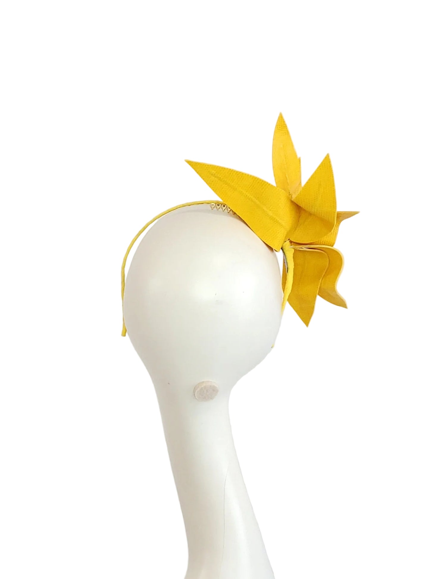 A bright yellow fascinator headpiece with a thin matching headband, displayed on a white mannequin head against a plain light background.