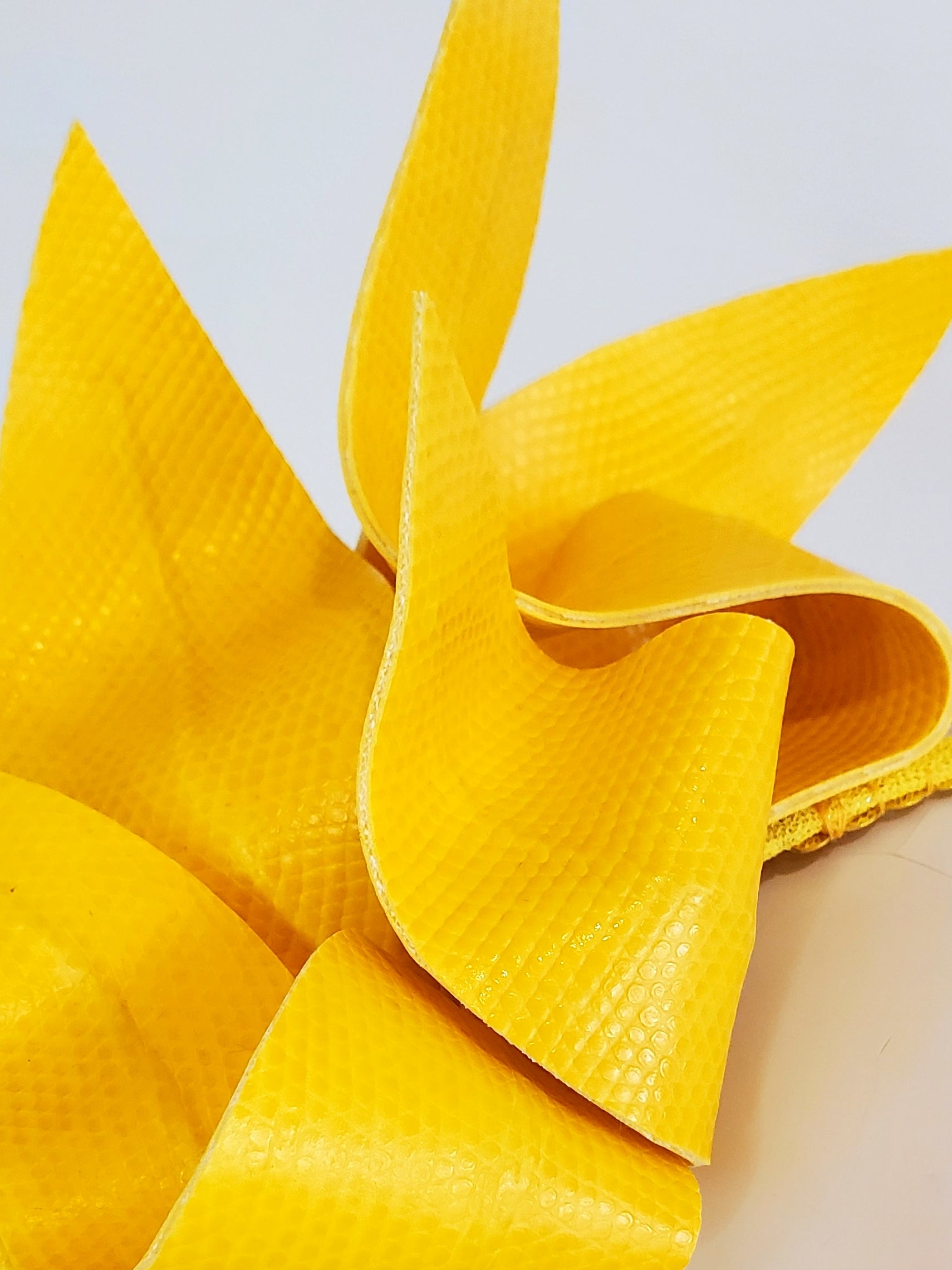 Close-up of a bright yellow fascinator
